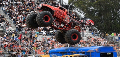 Stock image of a monster truck with an audience watching