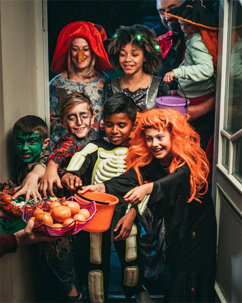 stock image of kids trick or treating 