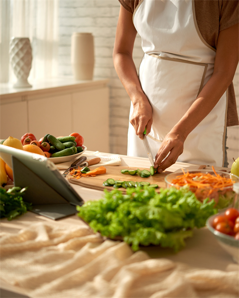 stock photo of person cutting vegetables