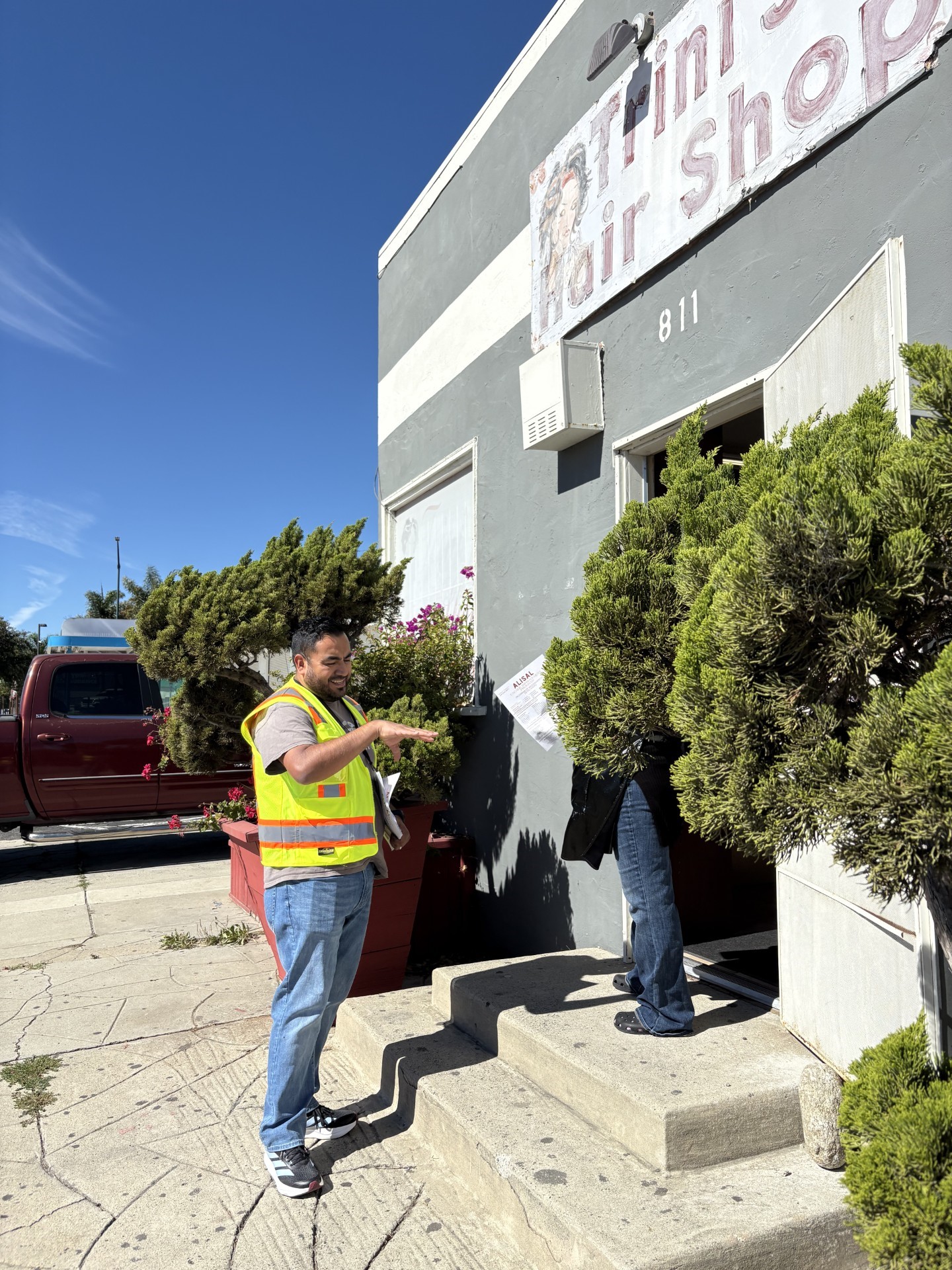 City of Salinas Code Enforcement staff member speaking with a resident outside a local business.