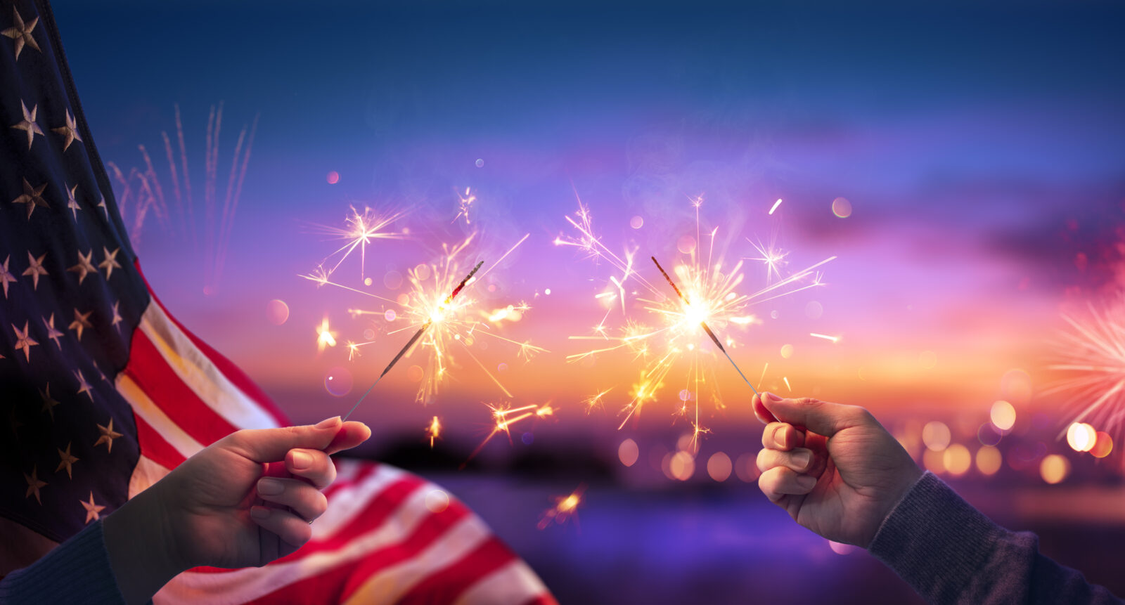 Image of a setting sky with a flag and sparklers 