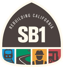 A grey badge with the letter SB1 in the middle with and arch above it that says rebuilding California. On the bottom portion of the badge there is icons of a train, road, construction worker and bus in their own 4 sections. 