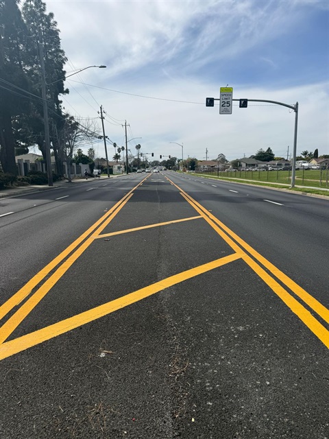 Two parallel lanes with yellow stripping lane in the middle to allow cars to turn either direction.